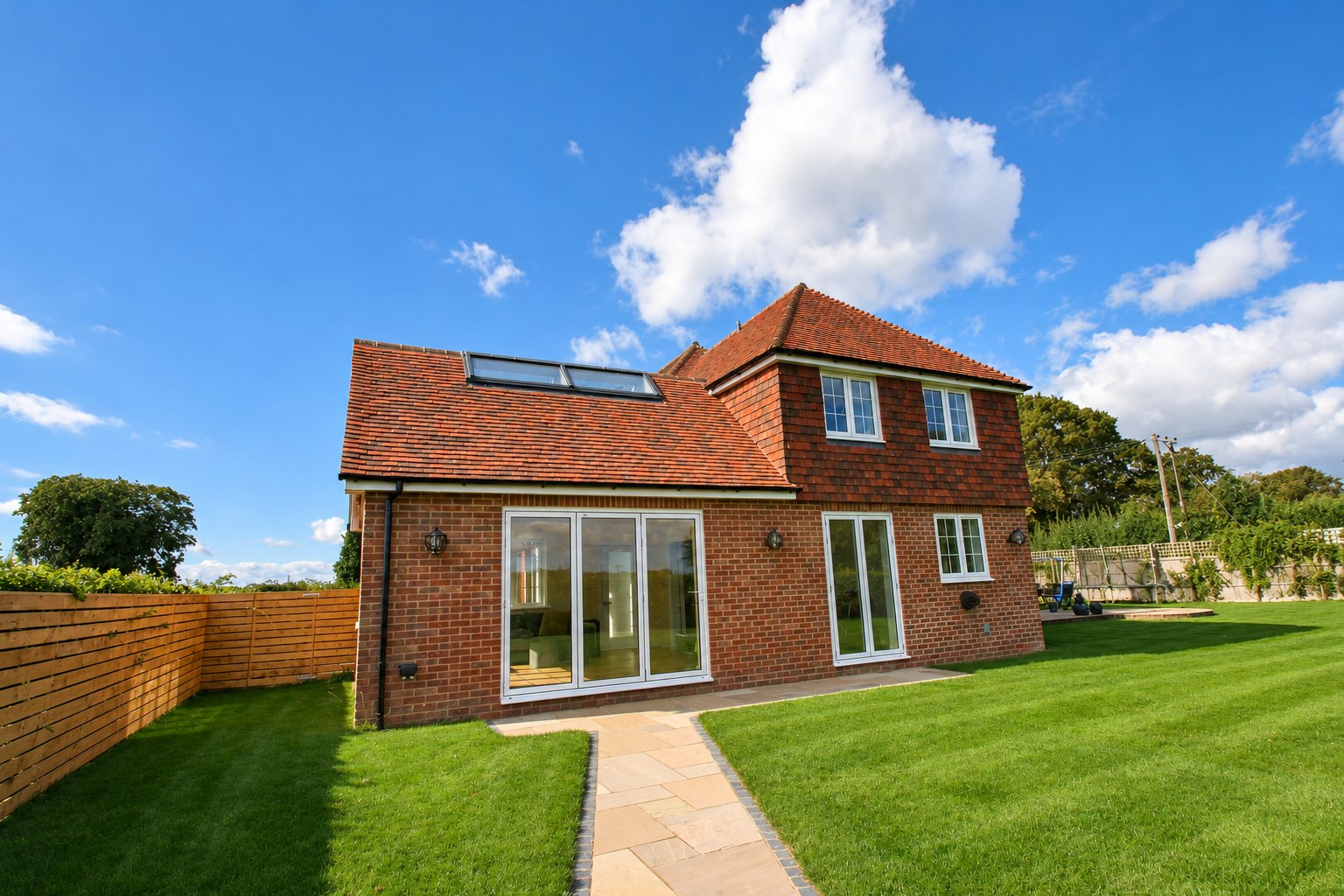 Brick garden room with wide glazed doors and rooflights, Kings Worthy