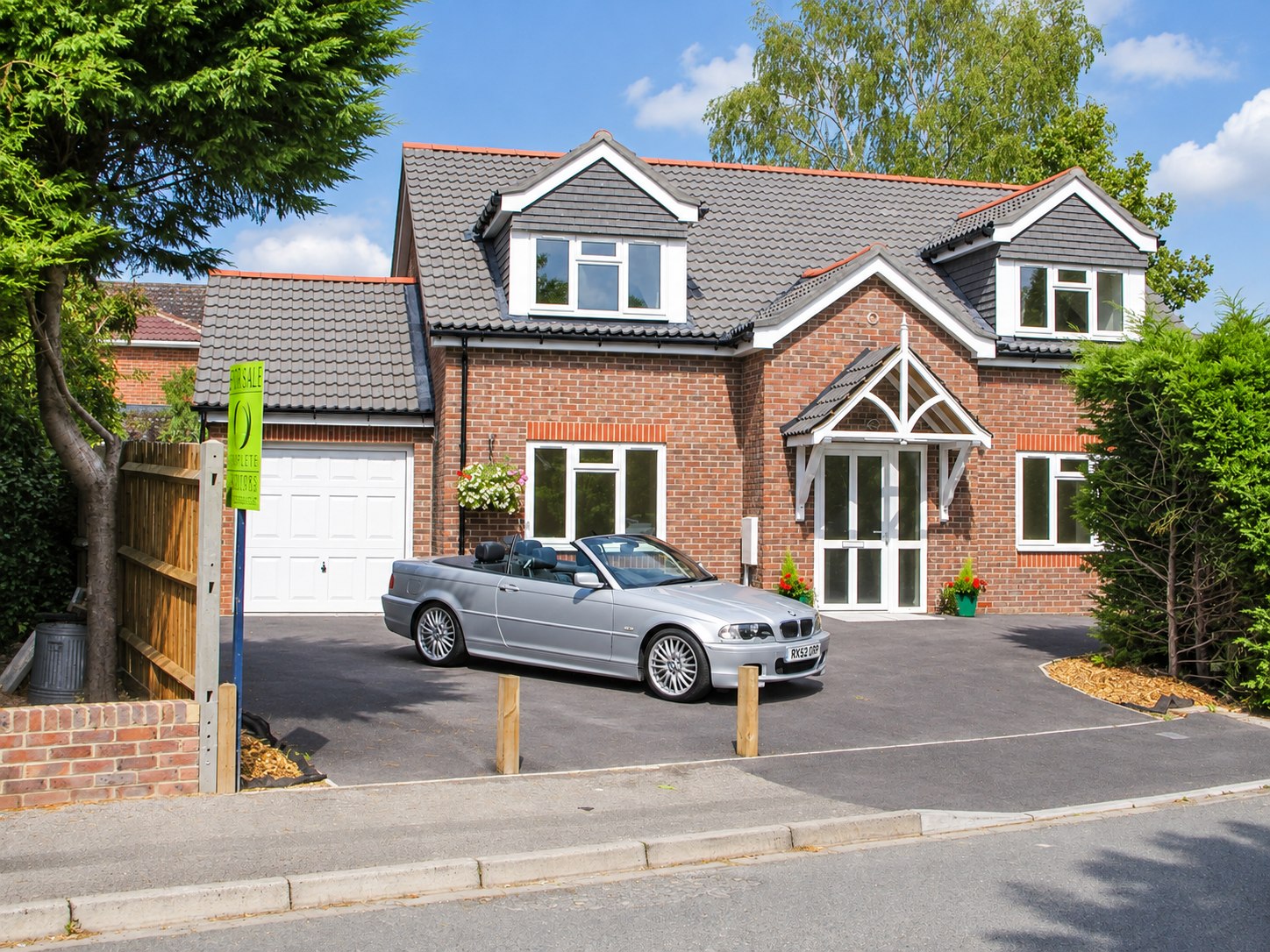 Brick home with dormer windows and a gabled porch
